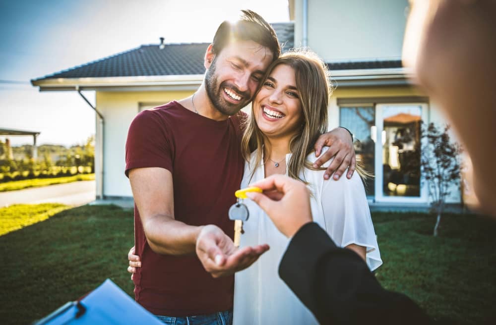 Couple receiving house keys.